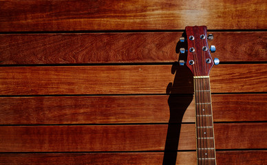 acoustic brown guitar in wooden stripes