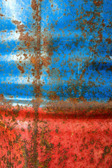 Wall painted metal barrels with rust