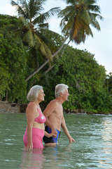 Fototapeta premium elderly couple rest at tropical beach