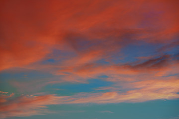 Naklejka na ściany i meble Red orange clouds in dramatic sunset sky