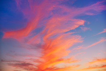 Fototapeta na wymiar Red orange clouds at sunset over blue