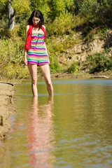 Mysterious pretty girl wanders in the shallow waters