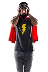 Superhero covering his ears