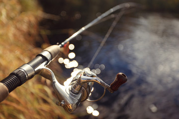 Autumn fishing spinning in his hand