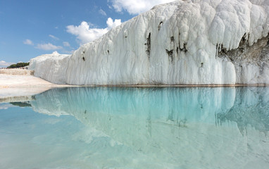 Turkey. Pamukkale. The hillside is covered with Cretaceous sediments and its reflection in the water.