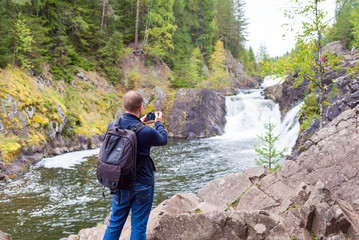 man take a photo on the camera outdoors