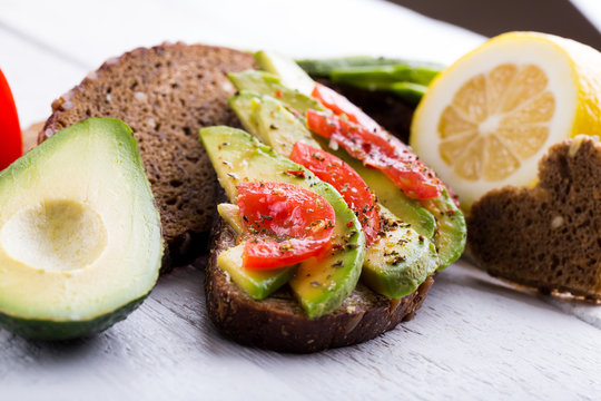 Tasty avocado sandwich with tomato for slimming.