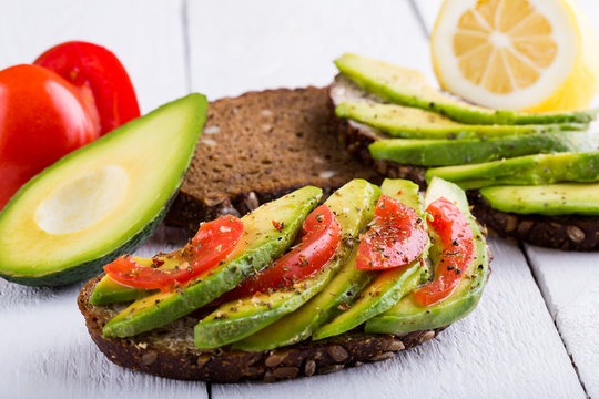 Tasty avocado sandwich with tomato for slimming.