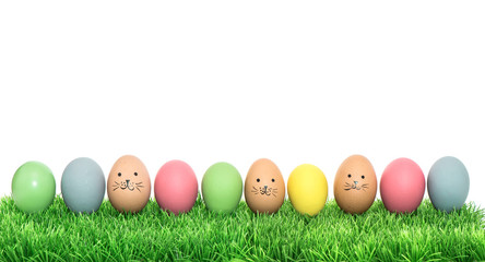 Colorful funny easter eggs in green grass