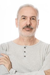 Obraz premium Close up portrait of a smiling attractive senior man looking dir