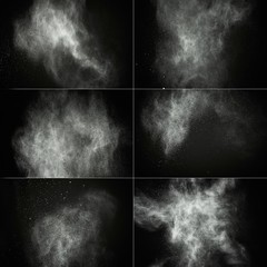 White powder exploding isolated on black