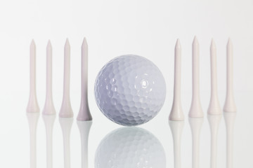 Golf ball and white  tees on the glass table