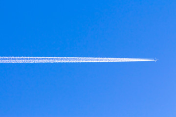 Reversing the trace of the plane in the blue sky without clouds