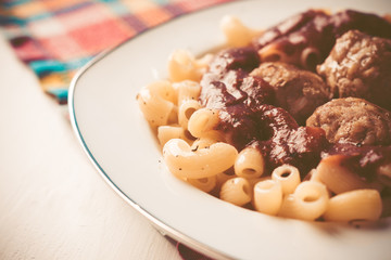 Pasta and meatballs with tomato sauce. Toned image.