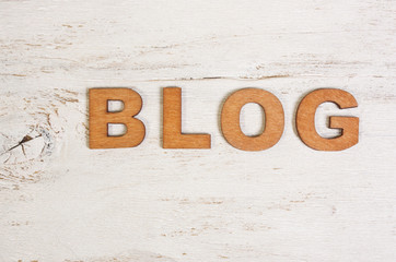 the word blog on a white background old wooden