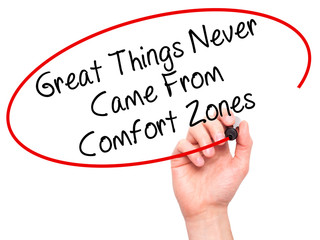 Man Hand writing Great Things Never Came From Comfort Zones with