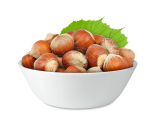 hazelnuts in porcelain bowl isolated on white background