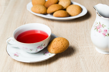 Cup of tea and cookies on wooden table