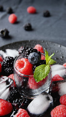 black berries and raspberries in a glass cup
