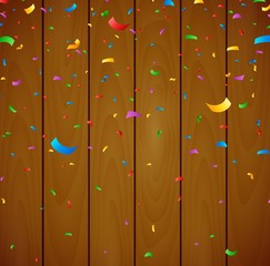 Colorful confetti on wooden background