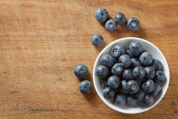 Blueberries in bowl on wooden. Blueberry contain antioxidant org
