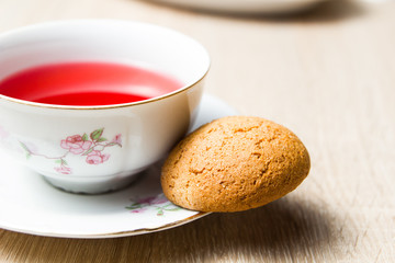 Cup of tea and cookies on wooden table