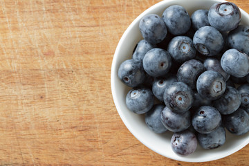 Blueberries in bowl on wooden. Blueberry contain antioxidant org