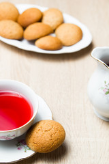 Cup of tea and cookies on wooden table