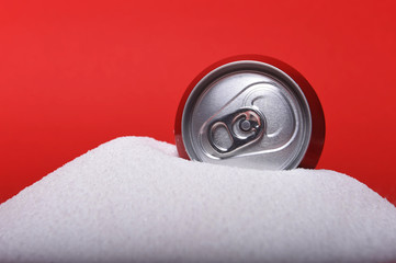 cola refreshing drink can sitting in pure white sugar mountain