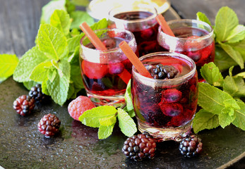 berry juice in a glass with berries, selective focus