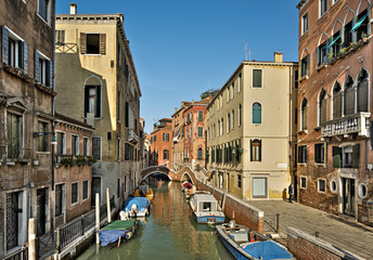 Fototapeta na wymiar typical canal with old colorful brick houses and boeats in Venice, Italy, Europe 