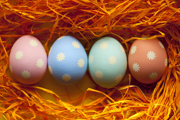 Four colored Easter eggs in the nest