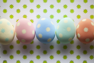 Colored Easter eggs on patterned background