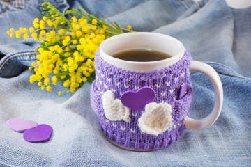 Winter cup of tea and mimosa flowers