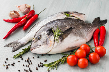 Raw fresh dorado fish with vegetables and spices