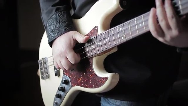 Close up video of bass guitar playing