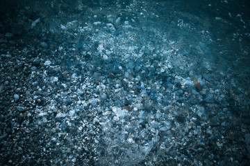 Wave on the pebble coast of sea. Selective focus. Toned