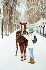 beautiful girl and horse in winter