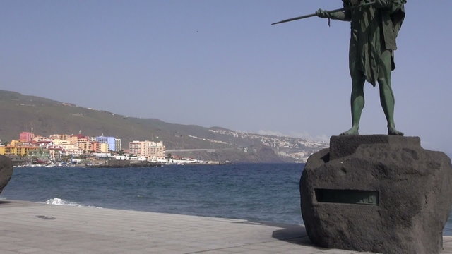 Metal sculptures of guanche on ocean shore in Candelaria