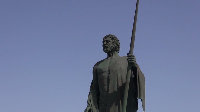 Metal sculpture of guanche on ocean shore in Candelaria, Tenerife, Spain