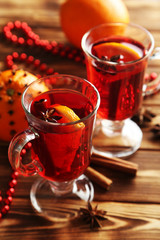 Mulled wine in glass on brown wooden table