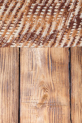 Knitted scarf on old wooden burned table or board for background