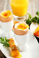 Boiled egg with toasts on a grey wooden table