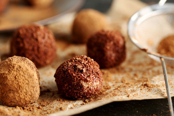 Sweet chocolate truffle on a black wooden table