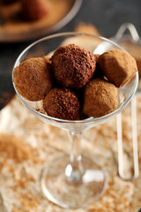 Sweet chocolate truffle on a black wooden table