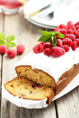 Raspberry cake on plate on grey wooden background
