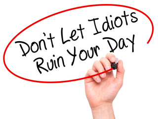 Man Hand writing Don't Let Idiots Ruin Your Day with black marke