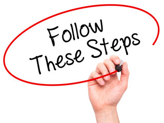 Man Hand writing Follow These Steps with black marker on visual