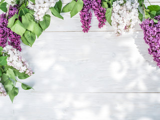 Blooming lilac flowers on the old wooden table.