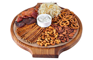 Mix of beer snacks on round wooden board